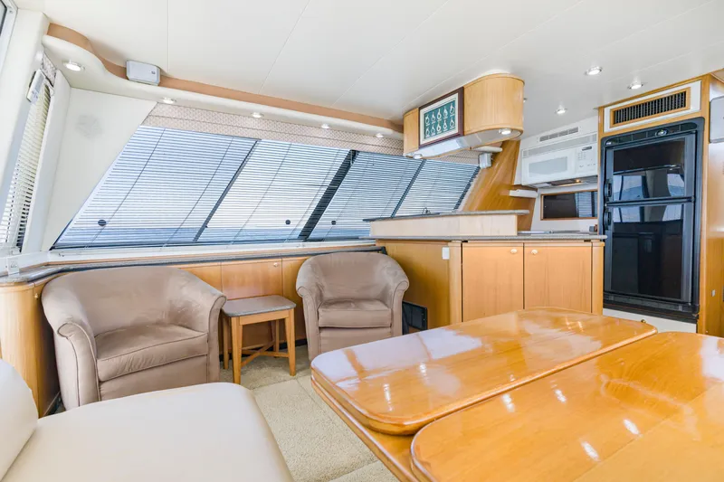 Never Say Never Yacht Photos Pics Luxurious interior of 1997 Bayliner 4788 Pilot House Motoryacht with modern kitchen and seating area.
