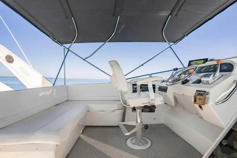 Never Say Never Yacht Photos Pics 1997 Bayliner 4788 Pilot House Motoryacht helm with seating and navigation controls.