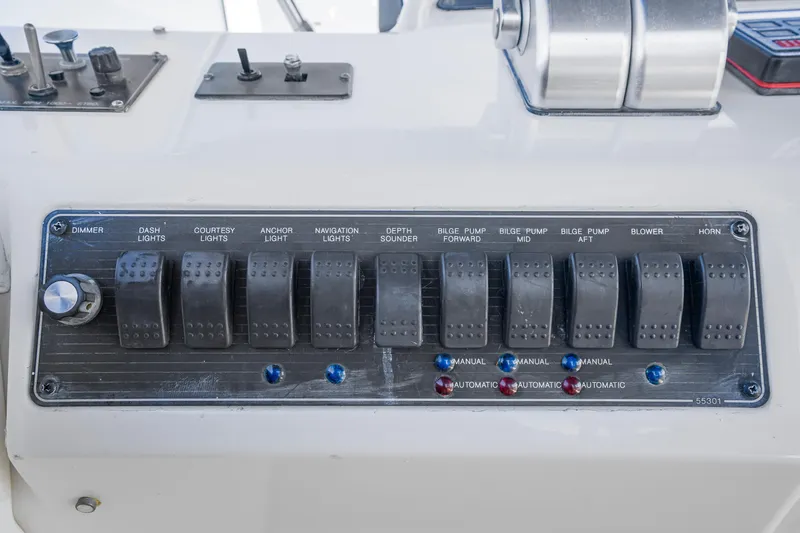 Never Say Never Yacht Photos Pics Control panel of a 1997 Bayliner 4788 Pilot House Motoryacht with various switches.