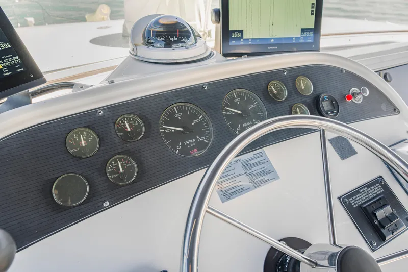 Never Say Never Yacht Photos Pics 1997 Bayliner 4788 Pilot House Motoryacht dashboard with gauges and steering wheel.