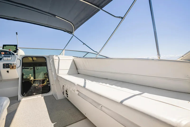 Never Say Never Yacht Photos Pics 1997 Bayliner 4788 Pilot House Motoryacht interior with white seating and helm station.