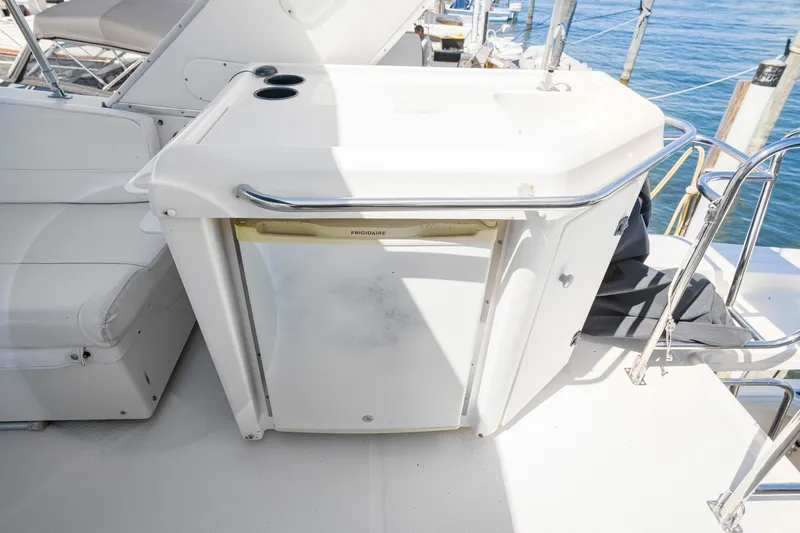 Never Say Never Yacht Photos Pics 1997 Bayliner 4788 Pilot House Motoryacht with outdoor kitchenette and Frigidaire fridge.