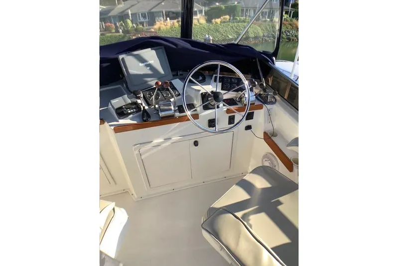 Ocean Baron Yacht Photos Pics 2001 Sabreline Sedan boat helm with steering wheel and navigation equipment.