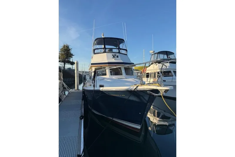 Ocean Baron Yacht Photos Pics 2001 Sabreline Sedan boat docked at marina under clear blue sky.