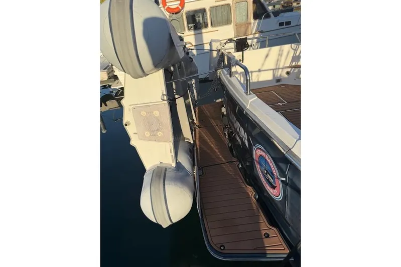 Ocean Baron Yacht Photos Pics 2001 Sabreline Sedan boat docked with inflatable dinghy attached.