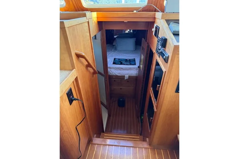 Ocean Baron Yacht Photos Pics 2001 Sabreline Sedan interior with wooden stairs leading to a cozy cabin.