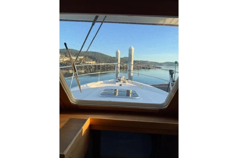 Ocean Baron Yacht Photos Pics View from 2001 Sabreline Sedan boat window, overlooking calm waters and distant hills.
