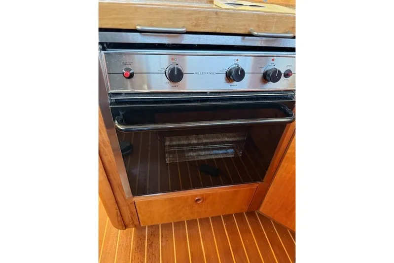 Ocean Baron Yacht Photos Pics Built-in oven on a 2001 Sabreline Sedan boat with wooden cabinetry.