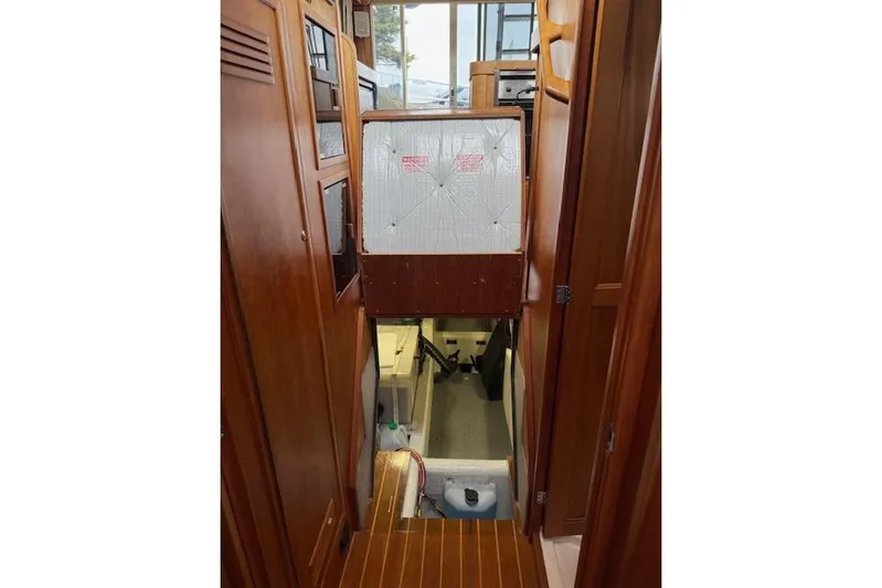 Ocean Baron Yacht Photos Pics Interior view of 2001 Sabreline Sedan, featuring wooden cabinetry and a stairway to lower deck.