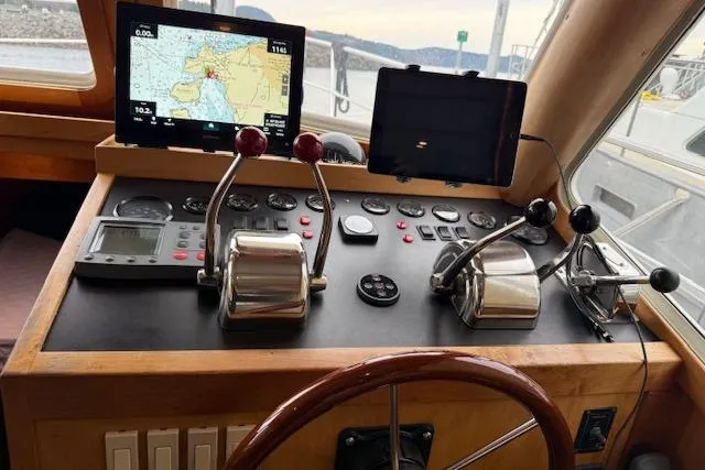 Ocean Baron Yacht Photos Pics Control panel of a 2001 Sabreline Sedan with navigation screens and throttle levers.