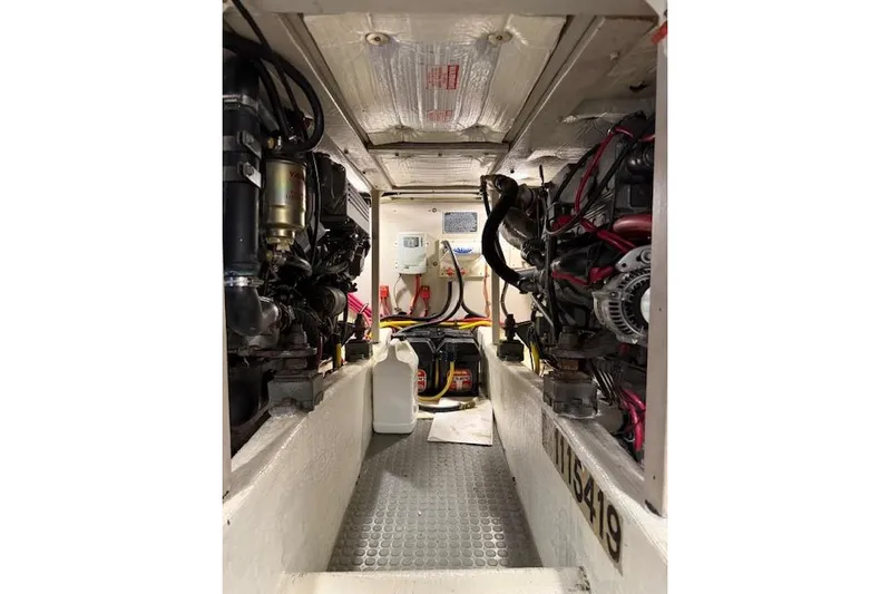 Ocean Baron Yacht Photos Pics Engine room of a 2001 Sabreline Sedan boat, showcasing mechanical components and wiring.