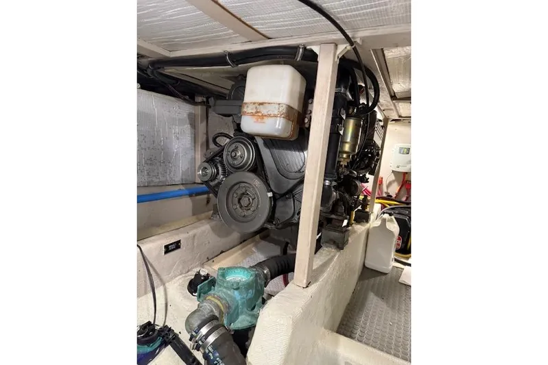 Ocean Baron Yacht Photos Pics Engine compartment of a 2001 Sabreline Sedan, showcasing mechanical components and hoses.