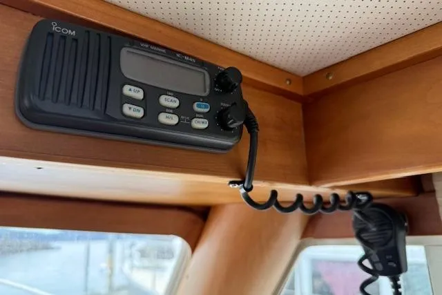 Ocean Baron Yacht Photos Pics 2001 Sabreline Sedan interior with Icom VHF marine radio installed on wooden panel.