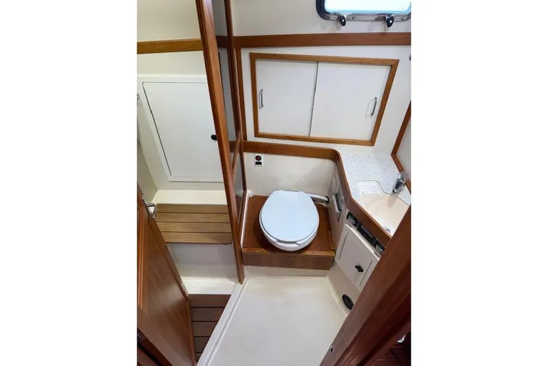 Ocean Baron Yacht Photos Pics 2001 Sabreline Sedan bathroom interior with wooden accents and compact design.