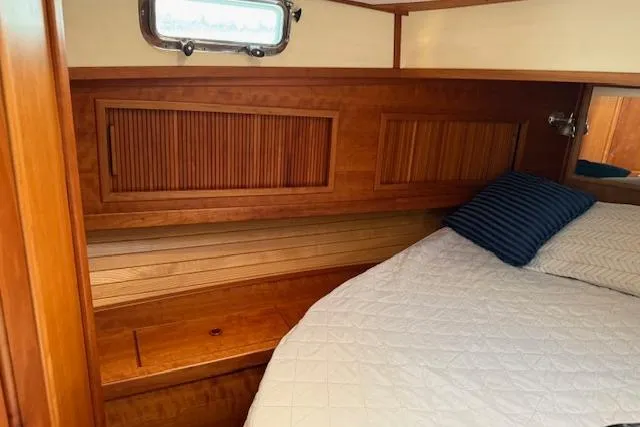 Ocean Baron Yacht Photos Pics 2001 Sabreline Sedan cabin with wooden interior and cozy bed.