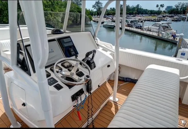  Yacht Photos Pics 2008 Intrepid 370 Cuddy boat helm with modern controls, docked in a scenic marina.