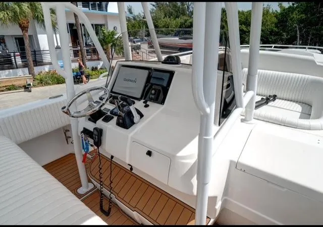  Yacht Photos Pics 2008 Intrepid 370 Cuddy boat cockpit with Garmin navigation system and white seating.