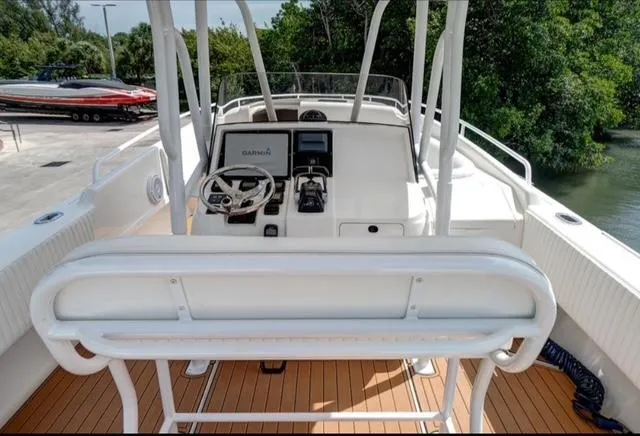  Yacht Photos Pics 2008 Intrepid 370 Cuddy boat helm with Garmin navigation, white seating, and wood deck.