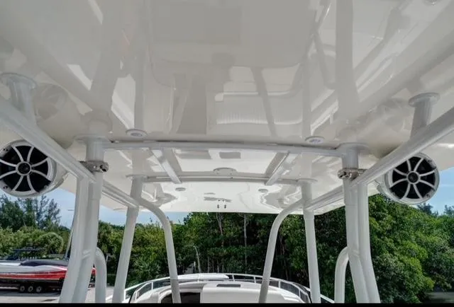  Yacht Photos Pics 2008 Intrepid 370 Cuddy boat with sleek white canopy and mounted speakers.