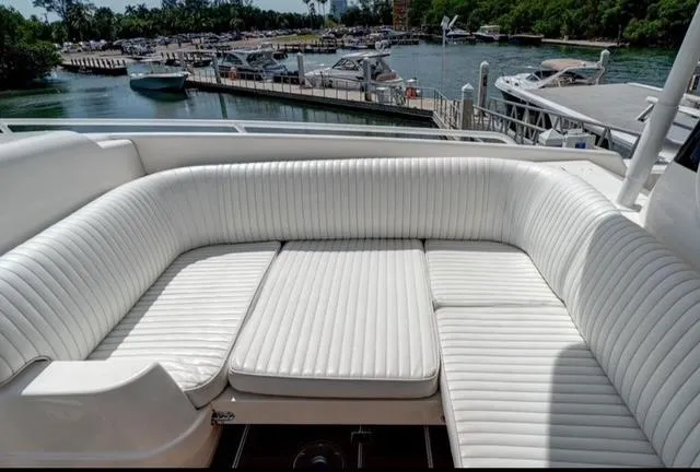  Yacht Photos Pics 2008 Intrepid 370 Cuddy boat with white cushioned seating, docked at a marina.