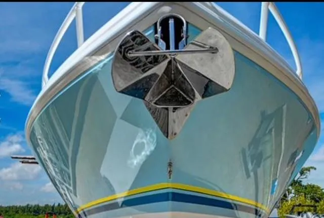 Yacht Photos Pics 2008 Intrepid 370 Cuddy boat, front view with anchor, under clear blue sky.