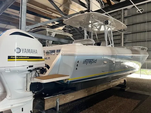  Yacht Photos Pics 2008 Intrepid 370 Cuddy boat with Yamaha outboard engine in storage facility.