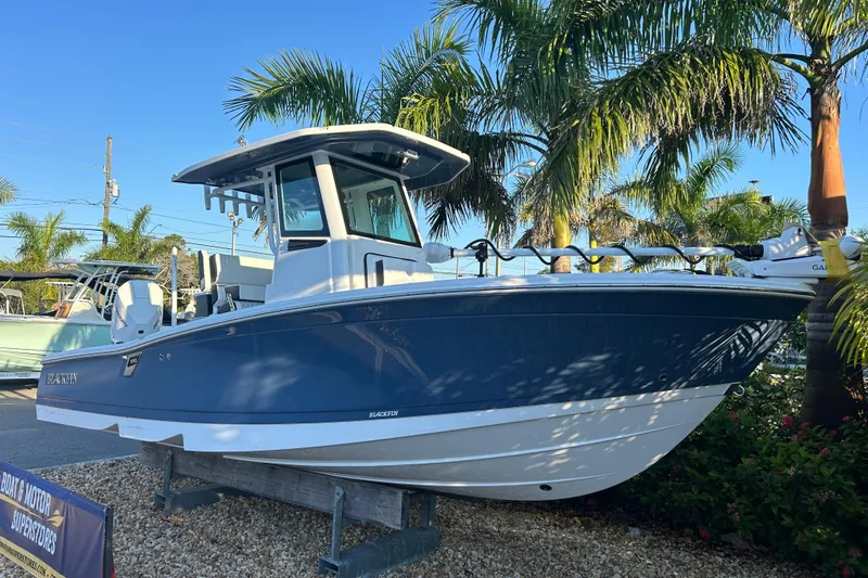  Yacht Photos Pics 2026 Blackfin 242 HB boat displayed outdoors with palm trees in the background.