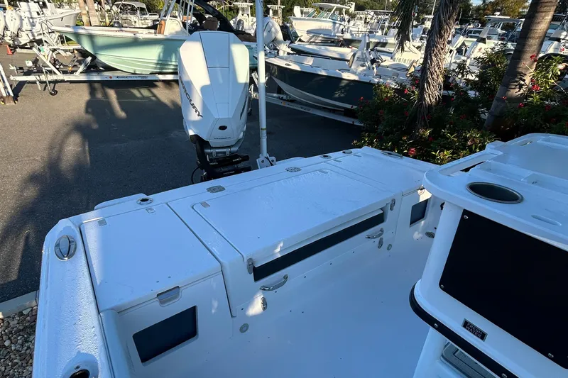  Yacht Photos Pics 2026 Blackfin 242 HB boat with outboard motor in a marina setting.