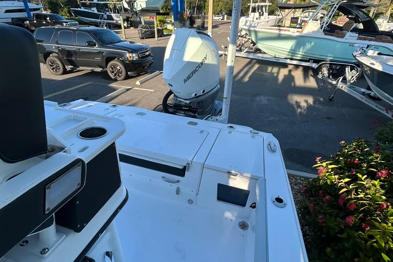  Yacht Photos Pics 2026 Blackfin 242 HB boat with Mercury engine in a parking lot.