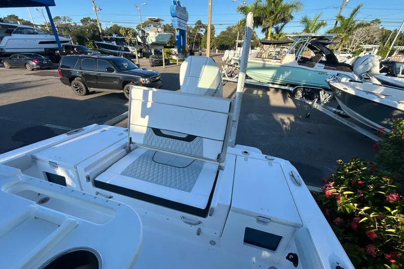  Yacht Photos Pics 2026 Blackfin 242 HB boat interior with seating, parked in a marina.
