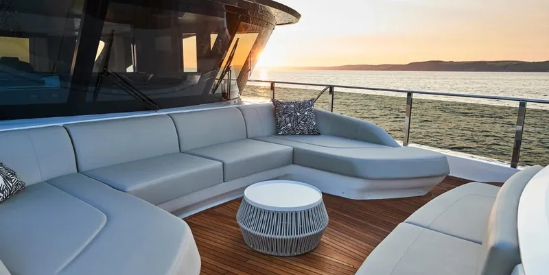  Yacht Photos Pics Luxurious 2026 Princess X95 Vista yacht deck with elegant seating and ocean view at sunset.