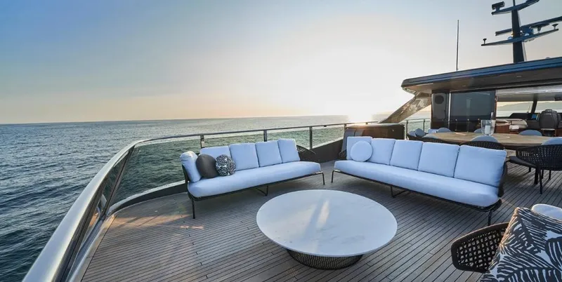  Yacht Photos Pics Luxury deck of 2026 Princess X95 Vista yacht at sunset, featuring elegant seating.