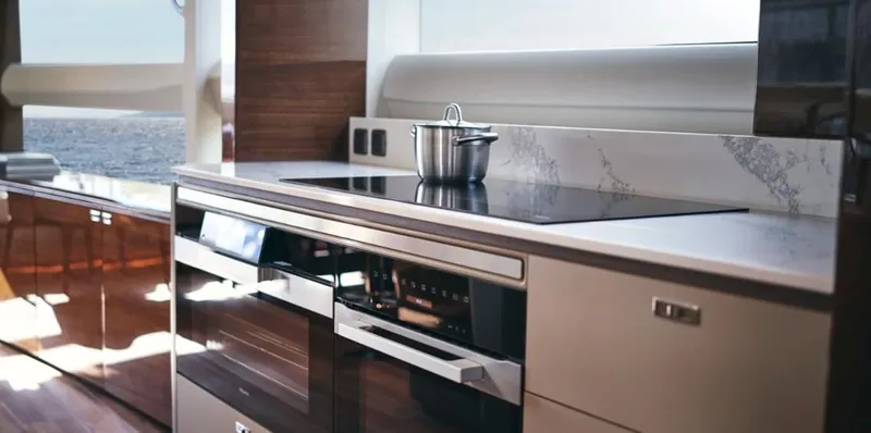  Yacht Photos Pics Modern kitchen in 2026 Princess X95 Vista yacht with sleek appliances and ocean view.
