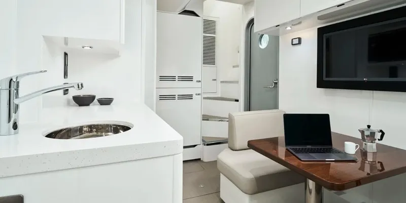  Yacht Photos Pics Modern interior of 2026 Princess X95 Vista yacht with kitchen and dining area.