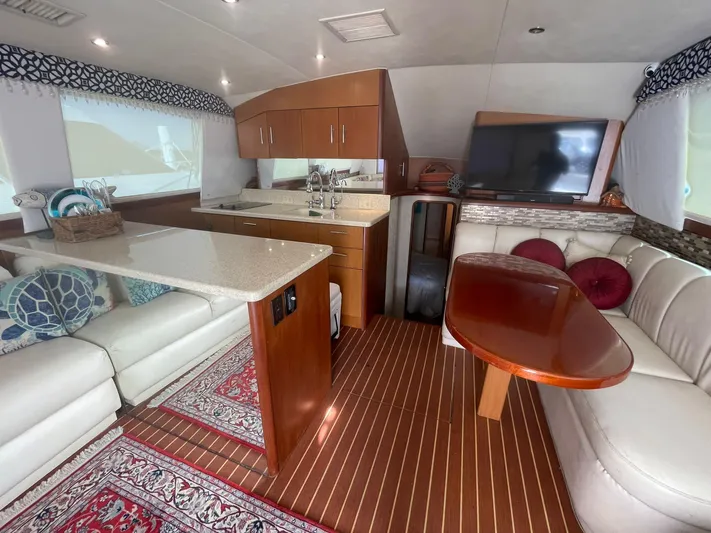  Yacht Photos Pics Luxurious interior of 2000 Ocean Yachts Convertible with modern kitchen and cozy seating area.