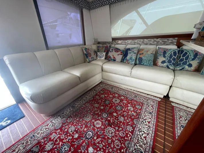  Yacht Photos Pics Luxurious interior of 2000 Ocean Yachts Convertible with white leather seating and vibrant rug.