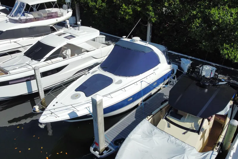  Yacht Photos Pics 2007 Cruisers Yachts 370 Express docked among other boats in a marina.