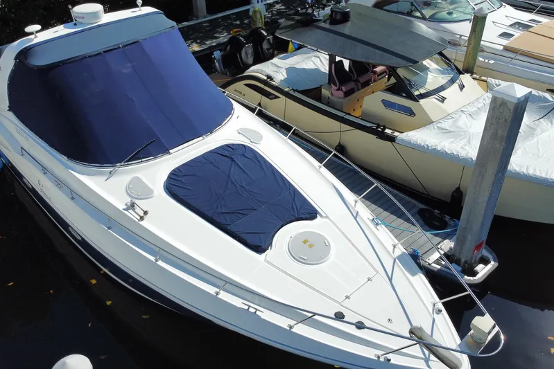  Yacht Photos Pics 2007 Cruisers Yachts 370 Express docked, featuring sleek design and blue covers.