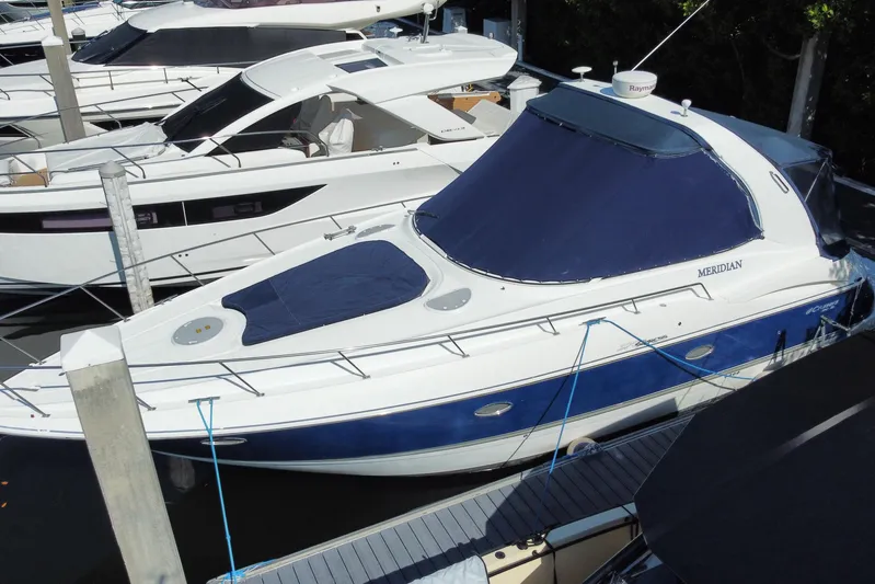  Yacht Photos Pics 2007 Cruisers Yachts 370 Express docked, featuring sleek design and blue cover.