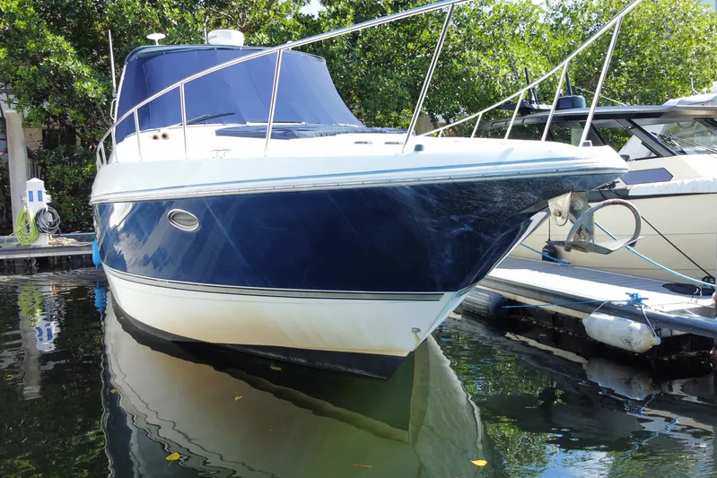  Yacht Photos Pics 2007 Cruisers Yachts 370 Express docked, featuring sleek design and blue hull.