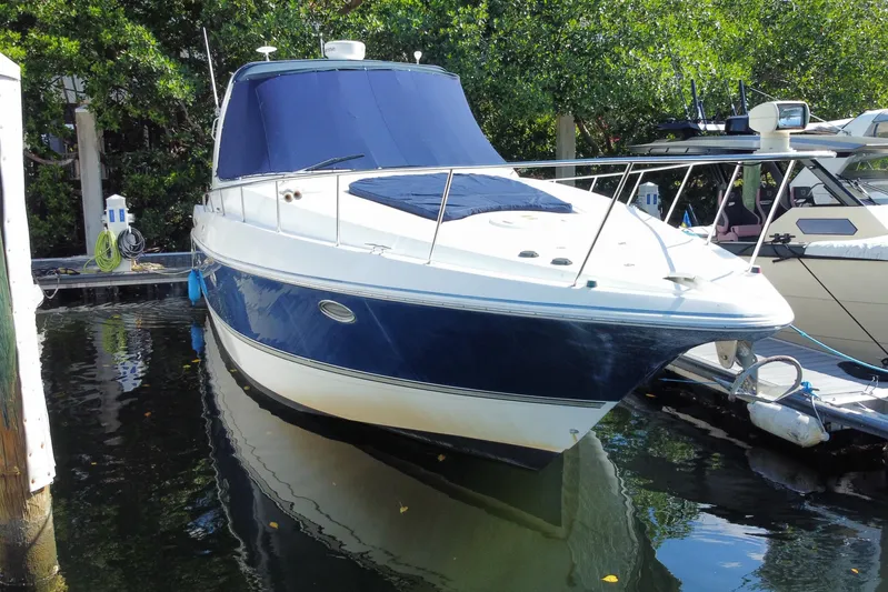  Yacht Photos Pics 2007 Cruisers Yachts 370 Express docked, featuring sleek design and blue hull.