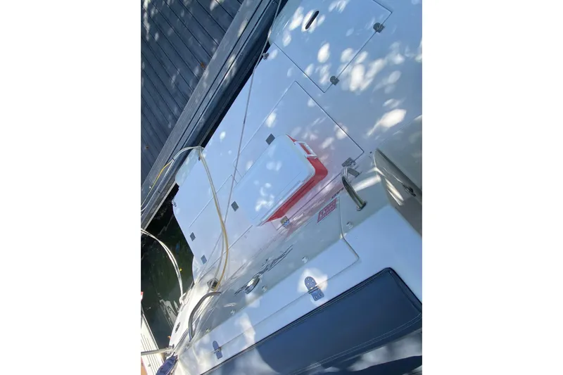  Yacht Photos Pics 2007 Cruisers Yachts 370 Express deck with storage compartments and cooler.