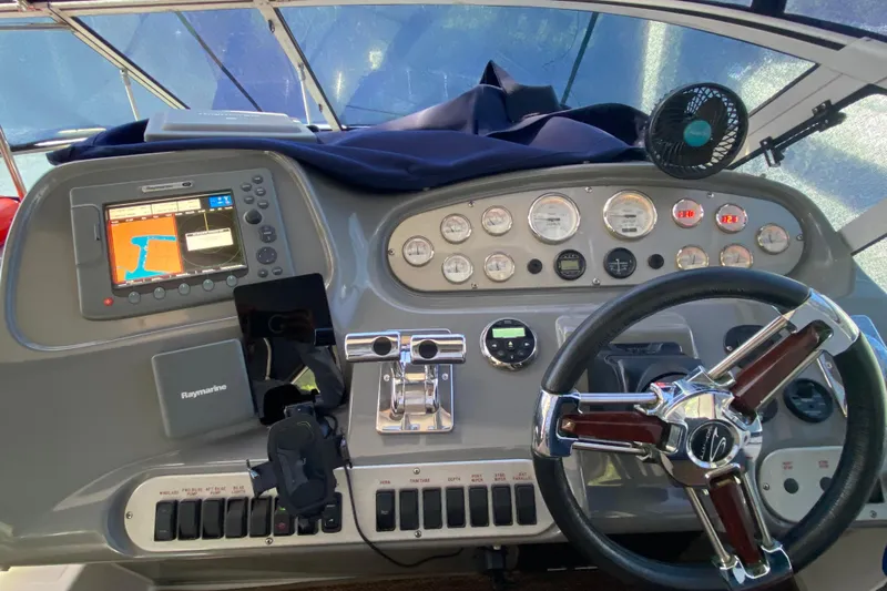  Yacht Photos Pics 2007 Cruisers Yachts 370 Express helm with navigation system and control panel.