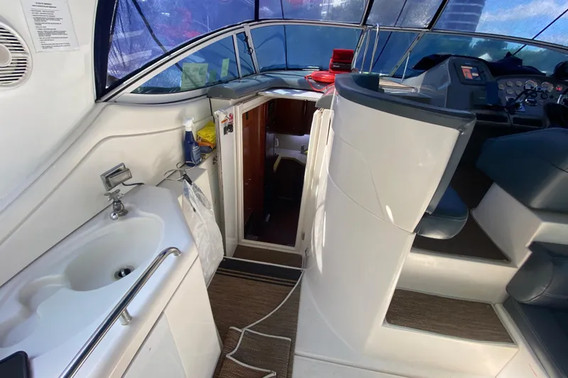  Yacht Photos Pics 2007 Cruisers Yachts 370 Express interior with helm, sink, and cabin entrance.