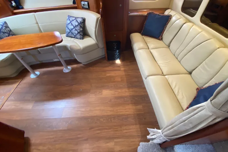  Yacht Photos Pics Interior of 2007 Cruisers Yachts 370 Express with beige seating and wooden table.