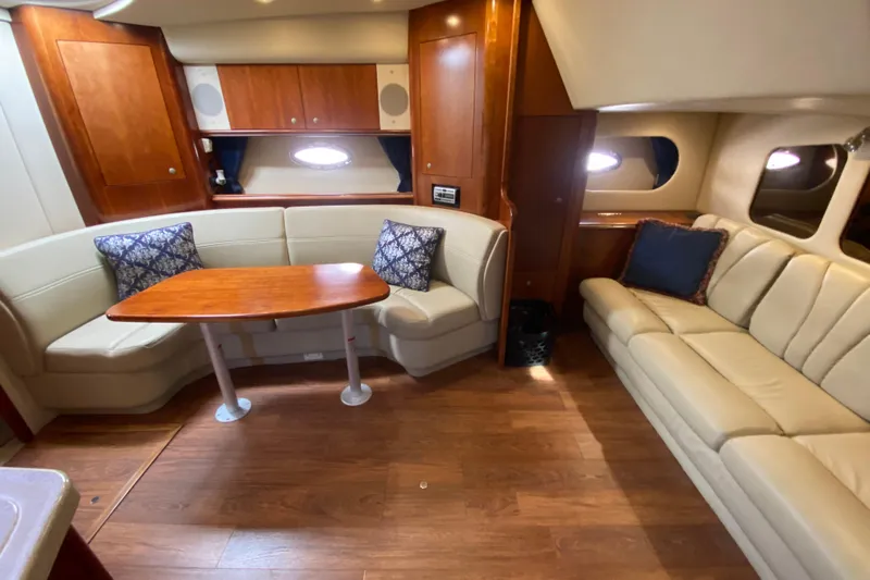  Yacht Photos Pics Luxurious interior of 2007 Cruisers Yachts 370 Express with leather seating and wooden table.