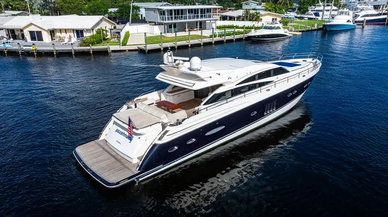  Yacht Photos Pics 2010 Princess V78 yacht cruising on a serene waterway near waterfront homes.