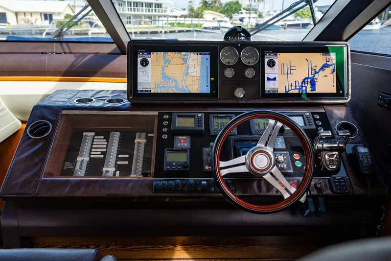  Yacht Photos Pics Control panel of 2010 Princess V78 yacht with navigation screens and steering wheel.