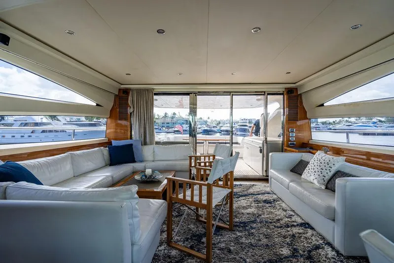  Yacht Photos Pics Luxurious interior of 2010 Princess V78 yacht with white seating and marina view.