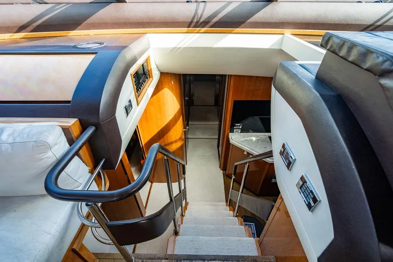  Yacht Photos Pics Interior staircase of 2010 Princess V78 yacht, featuring sleek design and modern finishes.